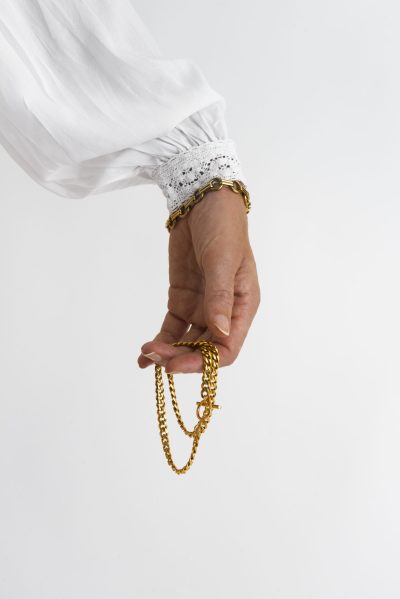 side-view-hand-holding-gold-chains side-view-hand-holding-gold-chains